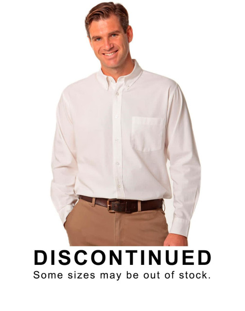 A long sleeve shirt in white with a button-down collar and a chest pocket, worn by a model. It features a logo.