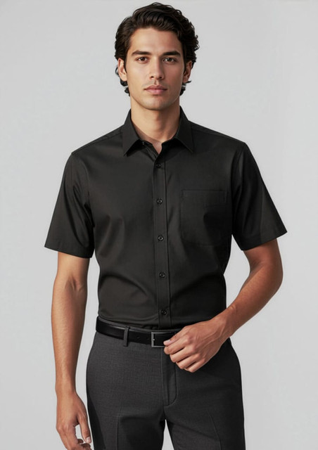 A short-sleeve black button-up shirt on a male model, featuring a chest pocket and a sleek design.