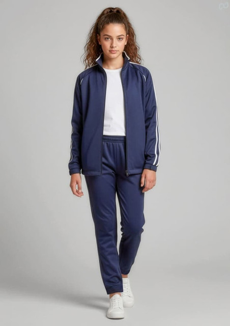 A girl models navy track pants with a matching jacket. The outfit features white stripes and a logo.