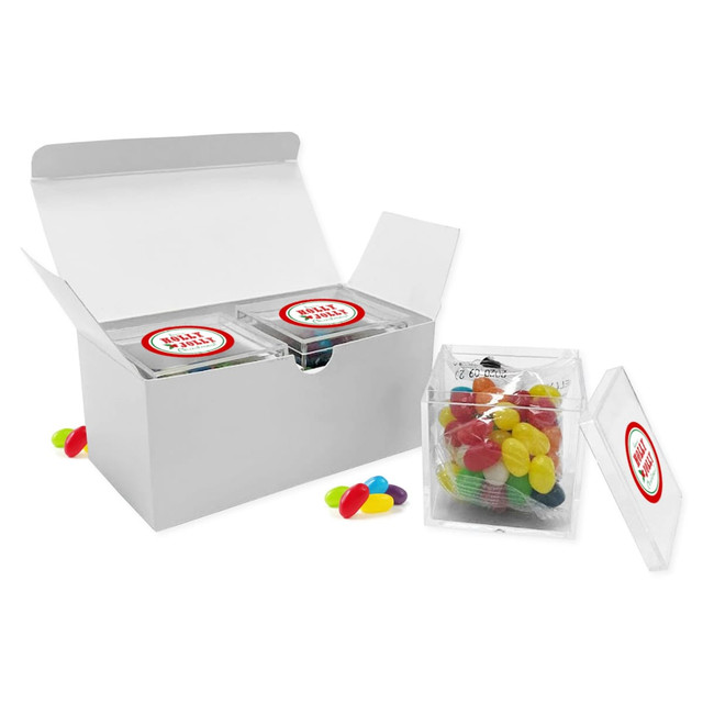 A white gift box containing two clear containers of colourful jelly beans, with additional jelly beans beside the box.