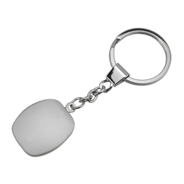 A metallic key ring with a smooth, white cubic pendant attached by a chain.