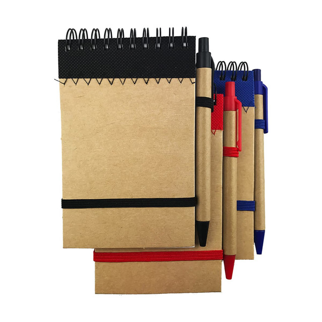 A recyclable paper jotter pad with spiral binding, accompanied by black, red, and blue pens. Features an elastic band.