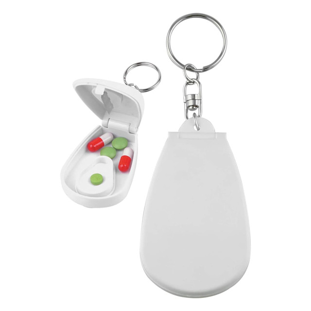 A white pill cutter with a keychain attachment, featuring an open compartment with green and red pills inside.