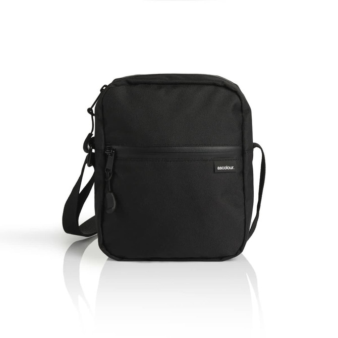 A black recycled transit bag with a front zip pocket and an adjustable shoulder strap, featuring a logo.