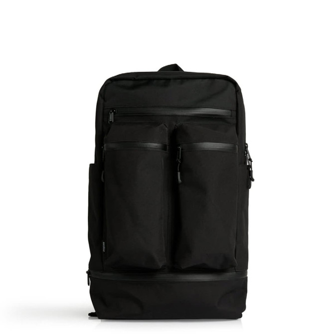 A black recycled travel backpack with multiple zippered compartments and a logo on the front.