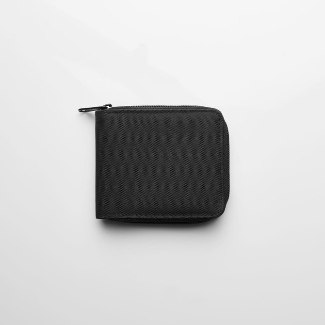 A black recycled zip wallet with a textured surface, featuring a zip closure and a small branding logo.