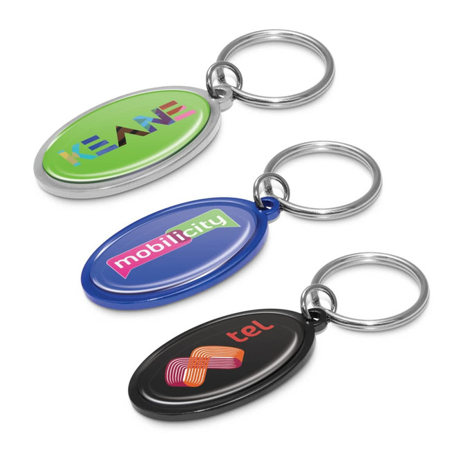 Three oval key rings in green, blue, and black, each featuring a different logo and a metal ring.