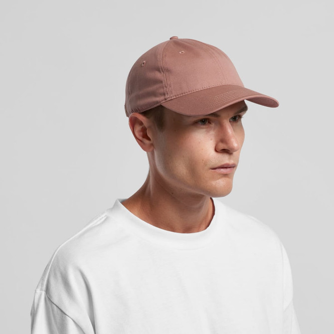 A pink cap with a curved brim and a logo, worn by a model in a white sweatshirt.