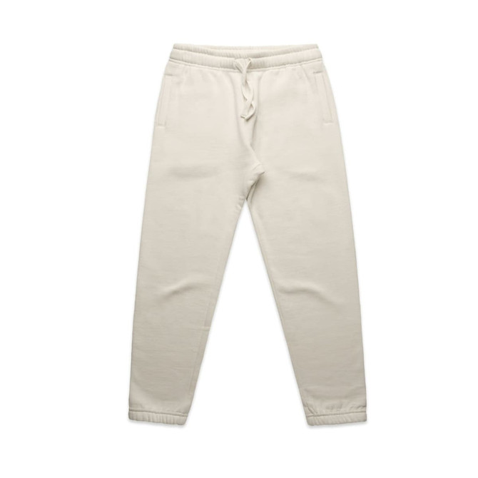 Cream track pants featuring an elastic waistband and side pockets. The pants have a simple design with a logo detail.