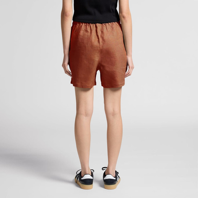 Linen shorts in a rust colour with an elastic waistband, featuring a simple design and no visible logos.