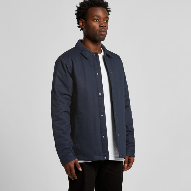 A work jacket in navy blue, featuring a collar and button-up front, worn by a standing male model.