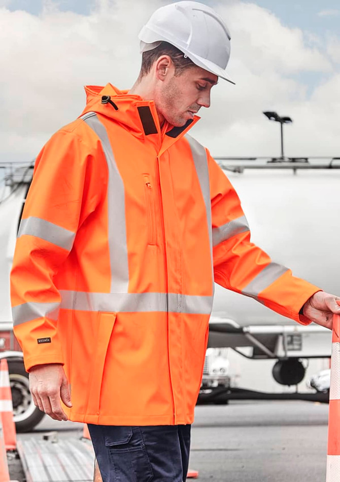 A heavy-duty waterproof jacket in bright orange with reflective stripes, worn by a person wearing a safety helmet.