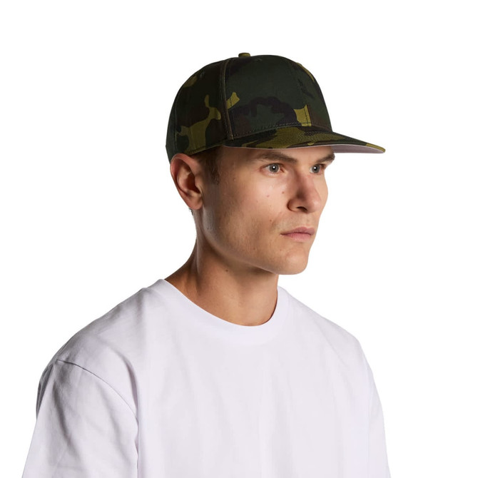A camo cap in shades of green and brown worn by a model. The cap features a branded logo.