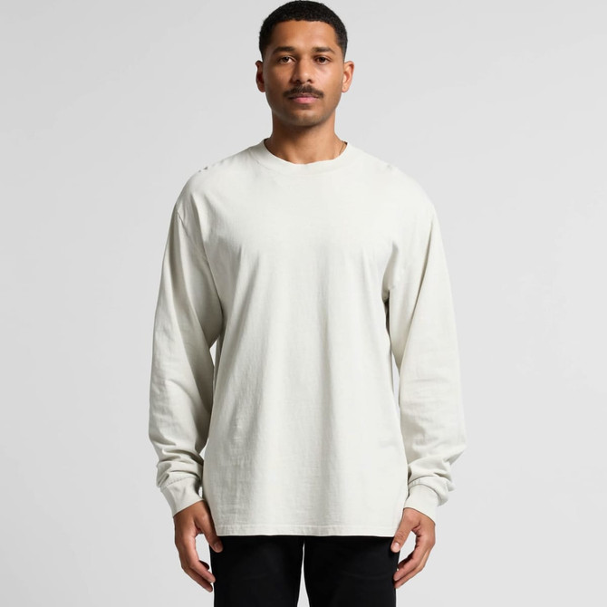 A light cream long sleeve tee displayed on a model, featuring a relaxed fit and a logo.