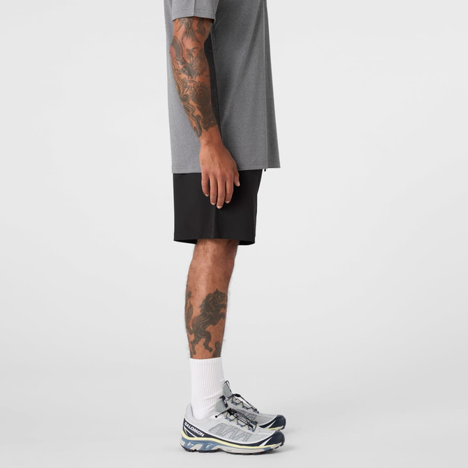 Active Pro Shorts in black, displayed on a person wearing a grey t-shirt and athletic shoes.