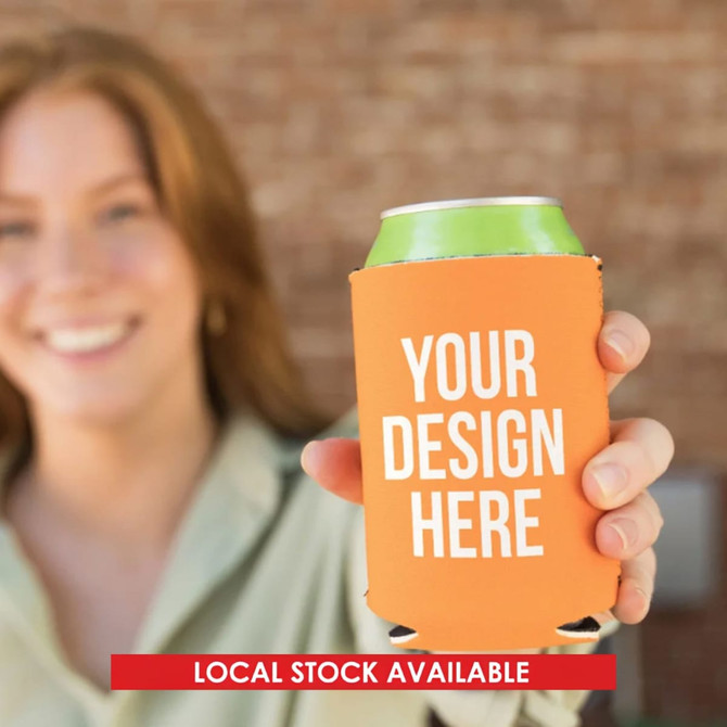 An orange neoprene stubby cooler is held by a person, featuring a placeholder for custom design.