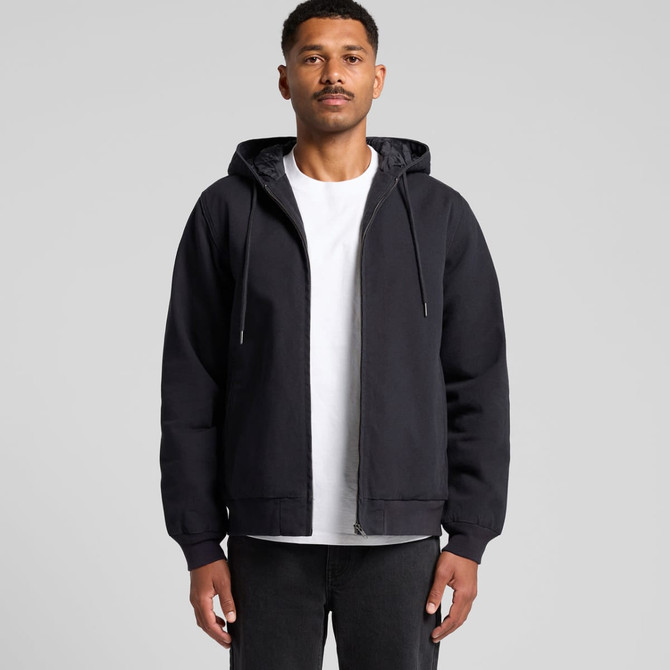 A black canvas bomber hood jacket with a zip front and drawstring hood, worn over a white t-shirt.