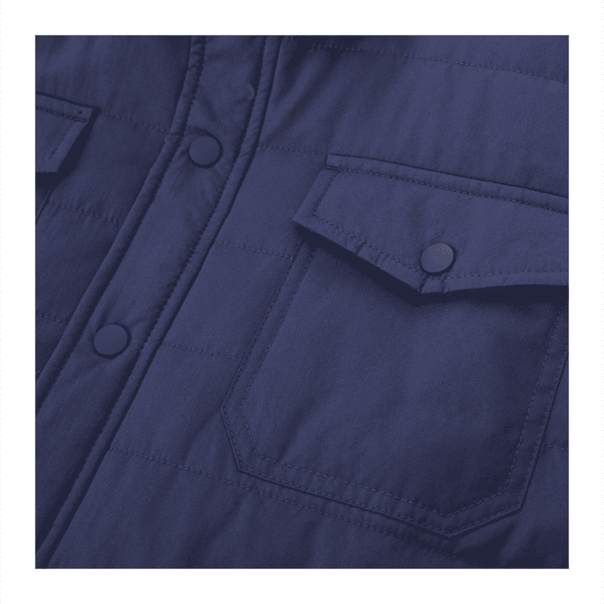 A navy insulated shacket with visible buttons and chest pockets, featuring a branded logo.