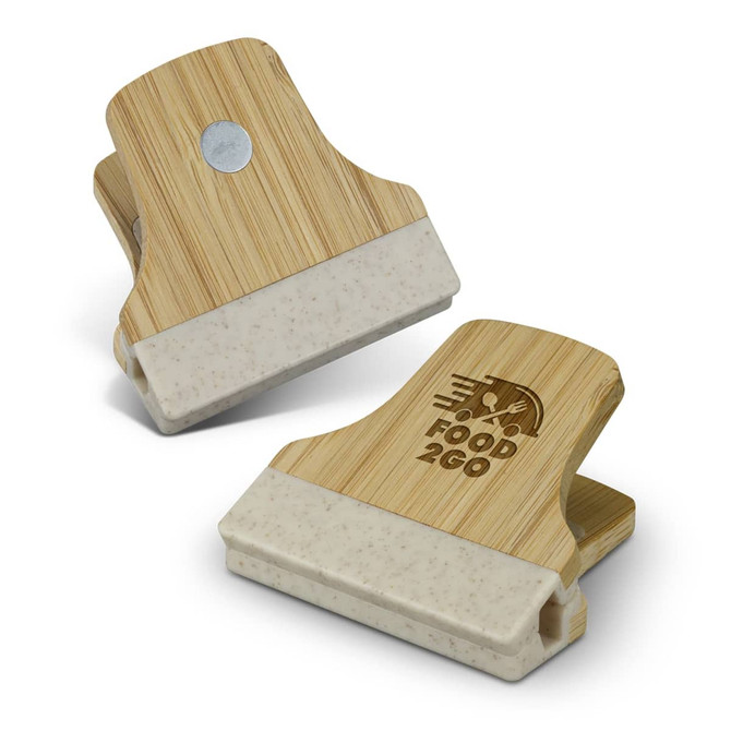 A bamboo clip with a beige section at the bottom, featuring a logo on one side.