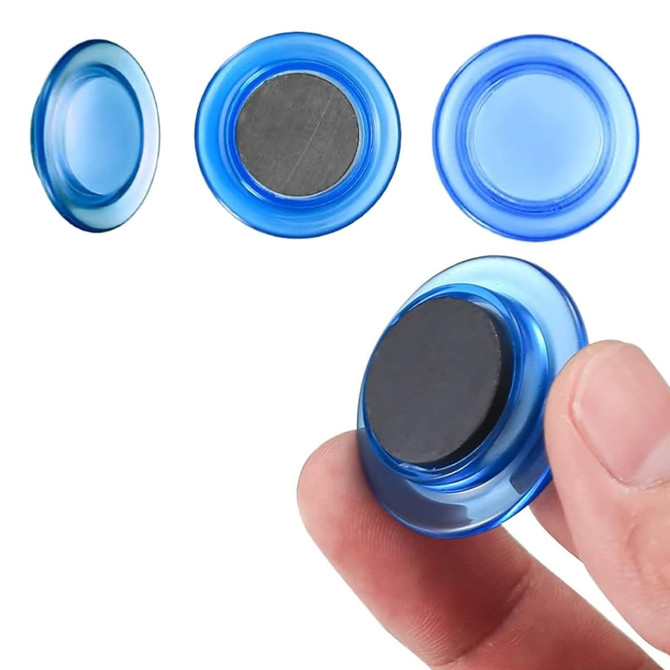 A blue plastic button magnet is held between fingers, showcasing its smooth surface and magnetic backing.