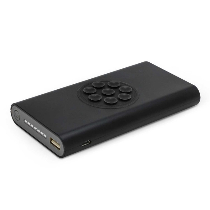 A black wireless power bank featuring a circular control panel and USB ports. It has a sleek, minimalist design.