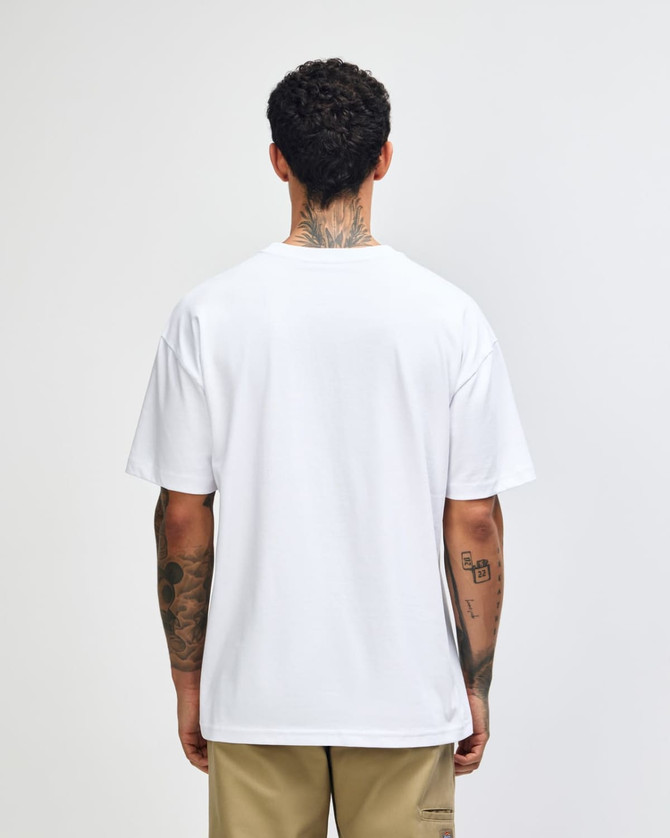 A white American Apparel Super Heavyweight T-Shirt viewed from the back, worn by a model with curly hair.