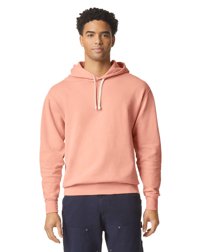 A lightweight hooded sweatshirt in a soft coral colour, featuring a drawstring hood and a logo.