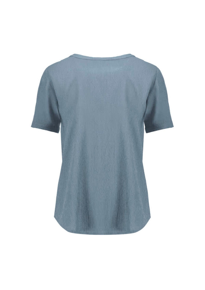 A blue women's short sleeve blouse with a textured finish and a relaxed fit, featuring a logo.