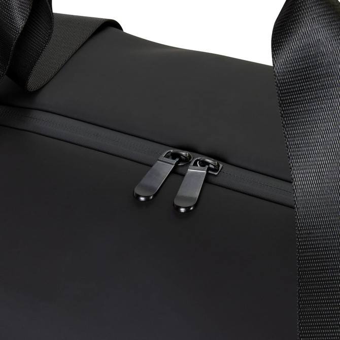 A black soft-touch duffle bag featuring a zip closure and fabric handles, with a subtle logo.