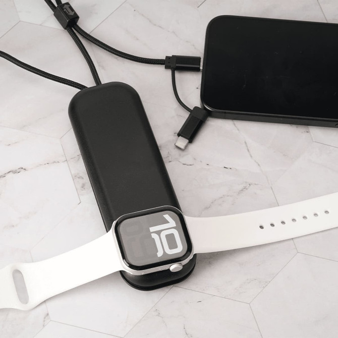 A foldable black charging cable with multiple connectors and a white wireless watch charger on a marble surface.