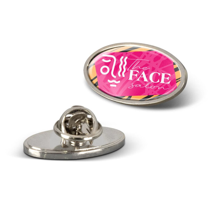 An oval lapel pin featuring a pink and white design with a logo. The pin has a silver back.