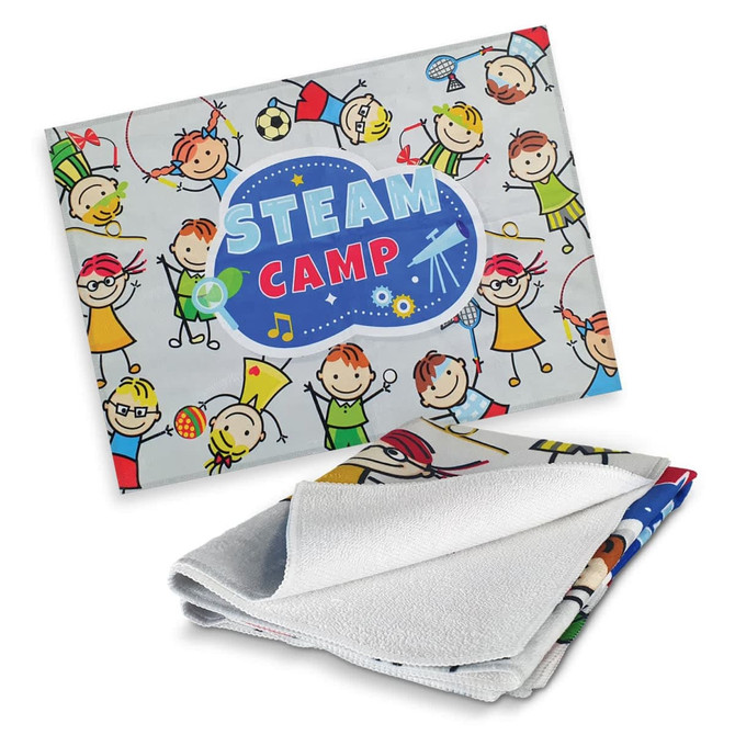 A full-colour tea towel featuring playful children's illustrations on a light background, with a logo present.
