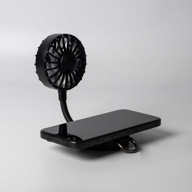A black rechargeable fan with a flexible neck, positioned next to a mobile phone on a flat surface. It features a branding logo.