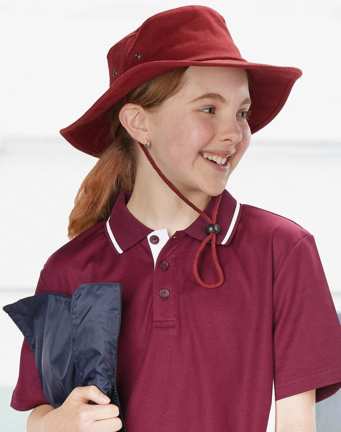 A beige bucket hat with a chin strap and a branded logo, featuring a wide brim for sun protection.