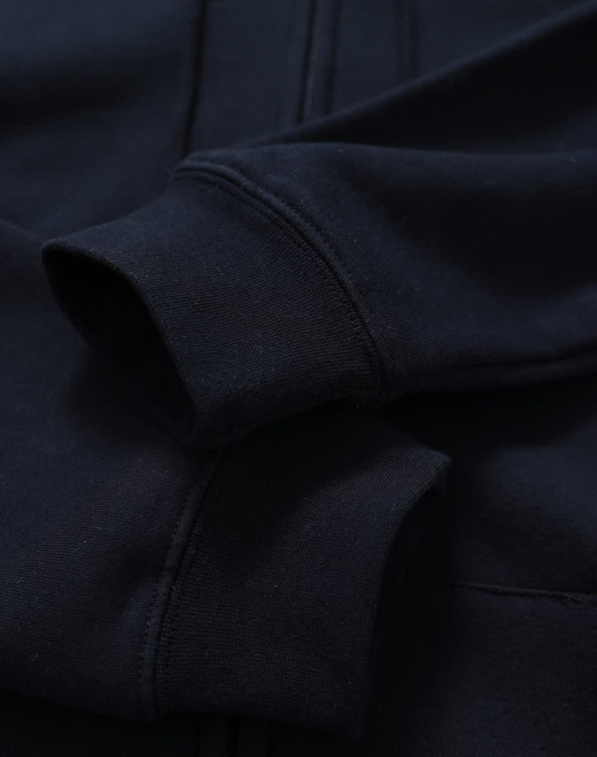 A men's full-zip fleecy hoodie in navy, featuring cuffed sleeves and a smooth fabric texture.