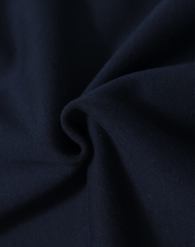 A close-up of soft navy fabric, showcasing the texture and quality of the material.