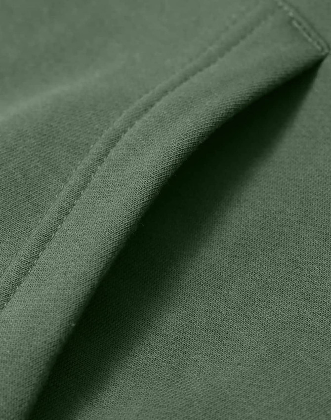 A close-up of a green fleece hoodie showcasing its soft fabric and stitching details. The hoodie has a logo.