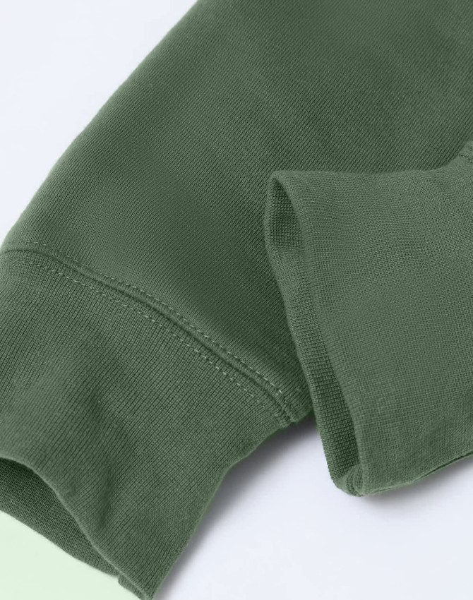 A close-up of an adult's hoodie in dark green, featuring a fleecy texture and a contrasting design.