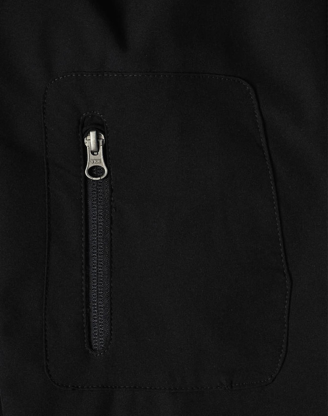 A black men's softshell jacket featuring a zipped pocket. The fabric appears smooth and high-tech. 