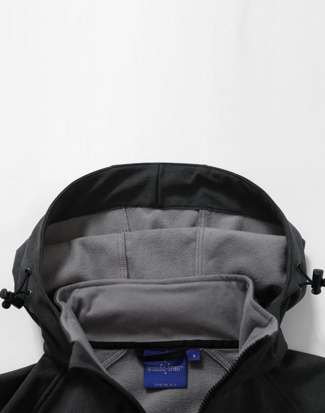 A black men's softshell full zip hoodie with a soft grey interior and a hood, featuring a logo.
