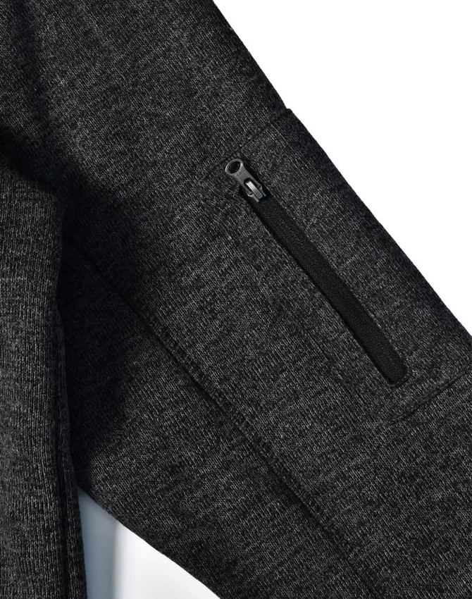 Men's heathered black bonded fleece jacket featuring a zippered pocket on the sleeve, and a subtle logo.