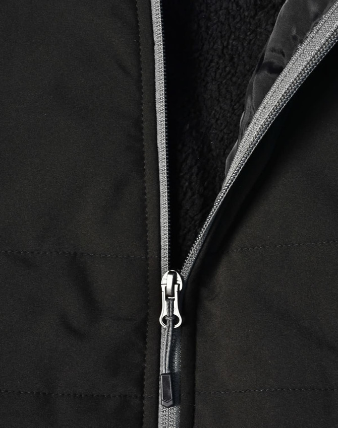 A black quilted jacket featuring a zippered closure and a soft interior lining. It has a logo on the surface.