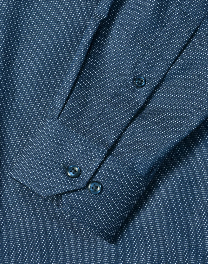 A blue men's long sleeve button-up shirt featuring a pin dot pattern and buttoned cuffs.