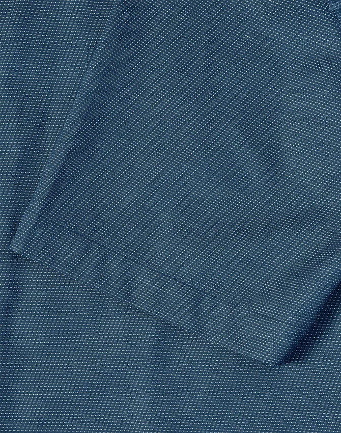 A close-up of a men's short-sleeve button-up shirt in a dark teal colour with a pin dot pattern.