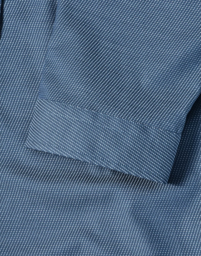 A blue pin dot stretch shirt featuring a 3/4 sleeve and folded cuff detail. Includes a logo.