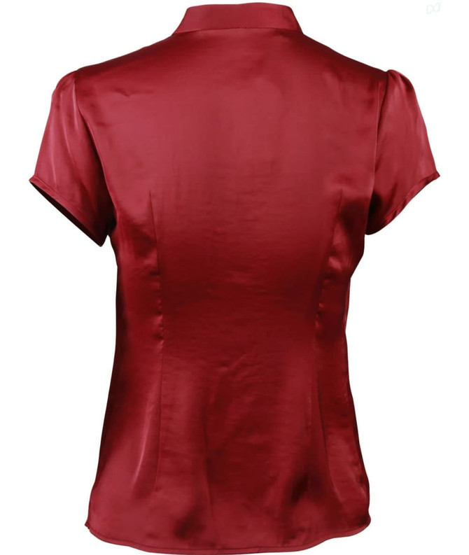 A women's tie neck blouse in a rich maroon colour with short sleeves and a smooth satin finish.