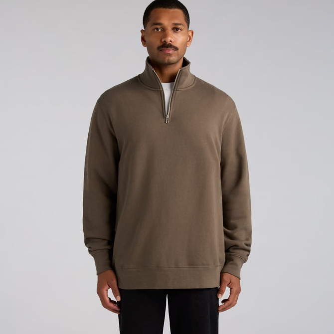 A man wearing a brown half zip crew jumper with long sleeves and a zipper collar. The product has a logo.