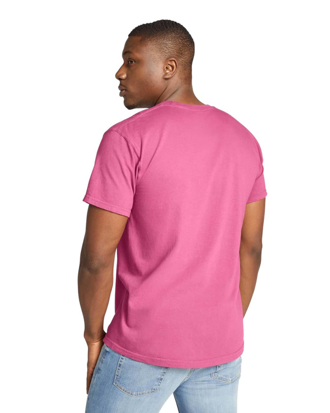 A heavyweight adult t-shirt in vibrant pink, featuring a round neck and short sleeves. The back view shows a plain design.