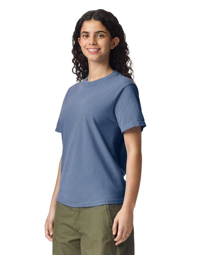 A blue heavyweight adult T-shirt on a model. The shirt features short sleeves and a relaxed fit.