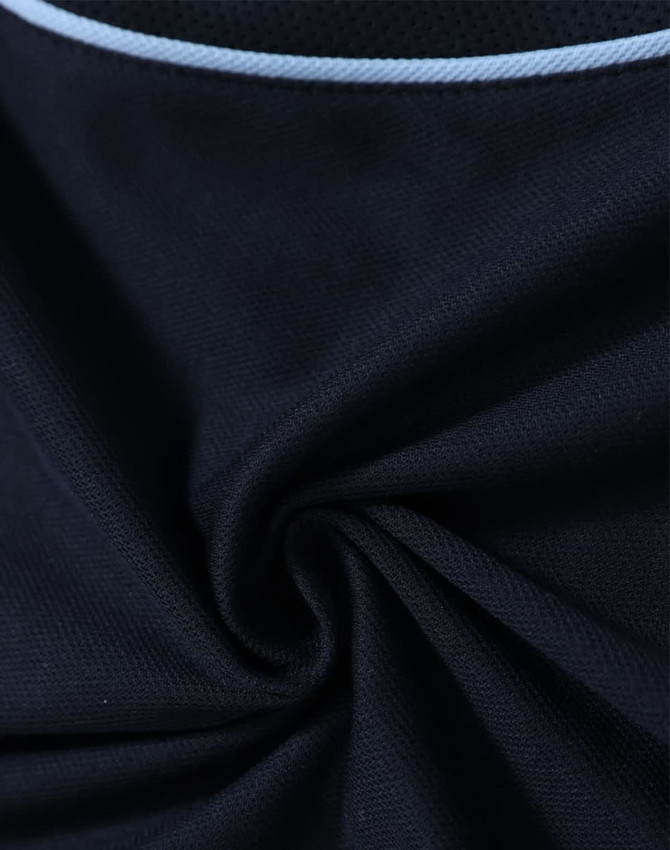A close-up of a navy polo shirt fabric with a light blue trim, featuring a logo.